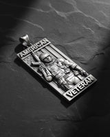 Side angle view of military pendant showing dimensional soldier figure with combat gear and patriotic text banners