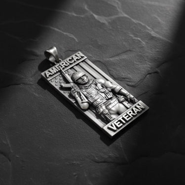 Side angle view of military pendant showing dimensional soldier figure with combat gear and patriotic text banners