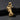 Gold vermeil Praying Hands Cross Pendant with detailed sculpted fingers resting on a textured black slate surface.