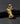 Gold vermeil Praying Hands Cross Pendant with detailed sculpted fingers resting on a textured black slate surface.