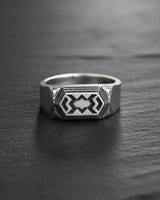 Front view of handcrafted dwarven ring showing detailed angular metalwork and oxidized finish details