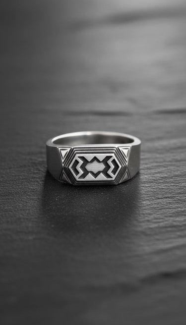 Front view of handcrafted dwarven ring showing detailed angular metalwork and oxidized finish details