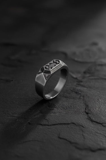 Side angle of silver dwarven ring highlighting geometric design elements and band thickness profile