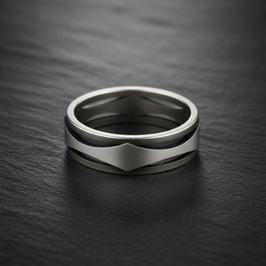 Close-up of contemporary silver wave ring band highlighting polished and matte contrast finishes