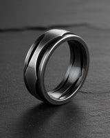 Side view of modern geometric wave ring showing brushed finish and flowing design details on dark slate