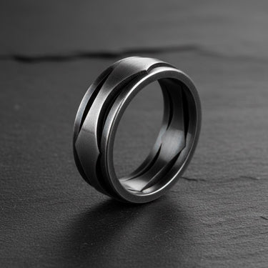 Side view of modern geometric wave ring showing brushed finish and flowing design details on dark slate