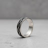 925 sterling silver infinity ring with interwoven pattern displayed on white marble surface showing elegant design