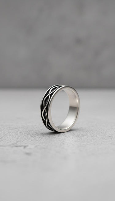 925 sterling silver infinity ring with interwoven pattern displayed on white marble surface showing elegant design
