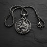 925 sterling silver fox pendant with botanical engravings displayed on dark slate background showing intricate detail