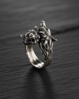 925 sterling silver double wolf head ring with detailed fur texture and oxidized finish on dark wooden background