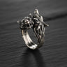 925 sterling silver double wolf head ring with detailed fur texture and oxidized finish on dark wooden background
