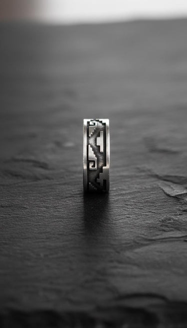 Close-up profile of sterling silver Aztec ring displaying intricate Mayan symbols and band thickness detail