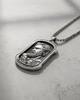 Close-up of handcrafted St. Jude pendant showing intricate facial details and radiating light pattern design