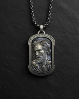 Religious pendant necklace featuring St. Jude with oxidized finish and chain displayed on black background
