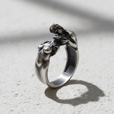 Handcrafted Silver Lovers Kiss Ring shown at an angle, highlighting the sculptural details of the couple's embrace.