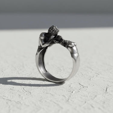 Side view of handcrafted romantic ring showing detailed sculptural figures and oxidized silver finish