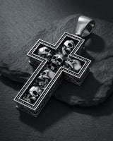 925 sterling silver skull cross pendant with multiple detailed skulls arranged in cross formation on dark slate