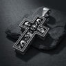 925 sterling silver skull cross pendant with multiple detailed skulls arranged in cross formation on dark slate