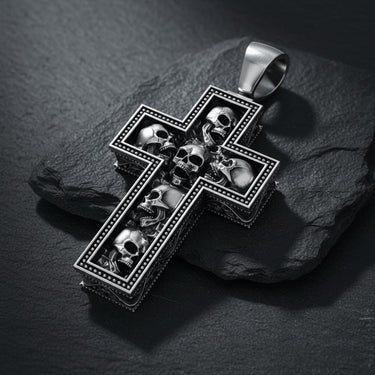 925 sterling silver skull cross pendant with multiple detailed skulls arranged in cross formation on dark slate