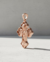 Close-up of Madonna cross pendant displaying intricate religious engravings and premium craftsmanship