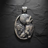 925 sterling silver wolf pendant featuring oxidized finish and detailed fur texture howling at full moon