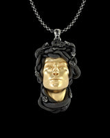 925 sterling silver Medusa pendant with gold vermeil face and oxidized snake hair details on black background