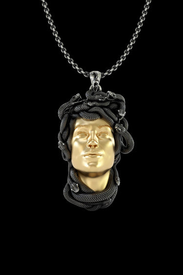 925 sterling silver Medusa pendant with gold vermeil face and oxidized snake hair details on black background