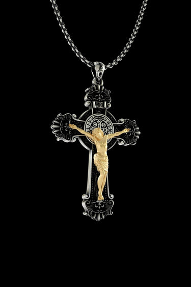Front view of handcrafted Catholic cross pendant showing baroque scrollwork and two-tone silver gold finish
