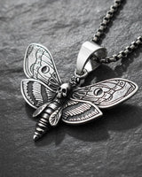 Silver Death Head Moth Pendant with an oxidized finish, showcasing detailed wing patterns on a dark slate background.