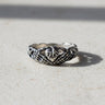 925 sterling silver claddagh skeleton hands ring with intricate bone detailing displayed on dark slate surface