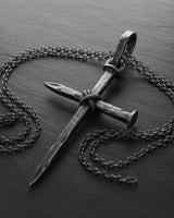 Gothic cross necklace with chain showing handcrafted nail design and sterling silver construction details