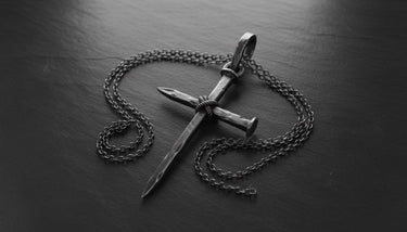 Gothic cross necklace with chain showing handcrafted nail design and sterling silver construction details