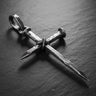925 sterling silver nail cross pendant with oxidized finish and wire binding detail on dark wood surface