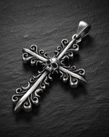 925 sterling silver cross pendant with gold vermeil finish and baroque filigree design on dark slate background
