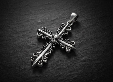 925 sterling silver cross pendant with gold vermeil finish and baroque filigree design on dark slate background