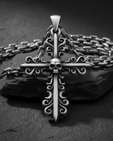 Silver cross pendant with chain displaying gothic baroque styling and dimensional filigree craftsmanship