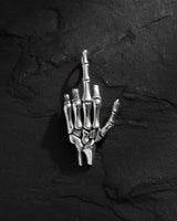 925 sterling silver skeleton hand pendant showing middle finger gesture on dark textured background