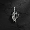 925 sterling silver skeleton hand pendant showing middle finger gesture on dark textured background