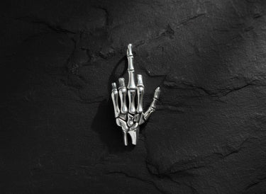 925 sterling silver skeleton hand pendant showing middle finger gesture on dark textured background