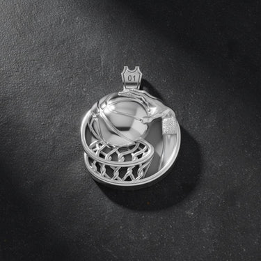 Side angle view of handcrafted basketball pendant showing textured ball and flowing net metalwork details