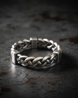 925 sterling silver twisted rope ring with chunky braided design and oxidized finish on dark textured background