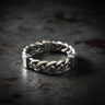 925 sterling silver twisted rope ring with chunky braided design and oxidized finish on dark textured background