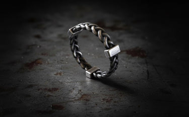 Close-up detail of twisted knot pattern on chunky sterling silver rope ring displaying artisanal craftsmanship and texture