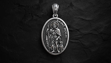 Silver Saint Roch religious pendant with oxidized details showing patron saint with dog in oval medal design