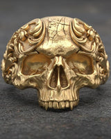 Close-up view of handcrafted baroque skull ring highlighting intricate metalwork and ornamental details