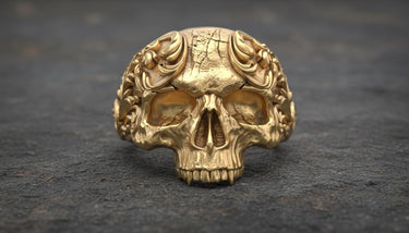Close-up view of handcrafted baroque skull ring highlighting intricate metalwork and ornamental details