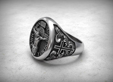 Side angle view of handcrafted religious signet ring showing ornate cross design and sterling silver band detail