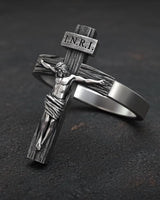 Side angle view of religious crucifix ring showing three-dimensional Christ figure and cross detail craftsmanship