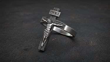 Side angle view of religious crucifix ring showing three-dimensional Christ figure and cross detail craftsmanship