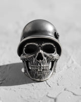 925 sterling silver soldier skull ring with military helmet displayed on textured white surface showing front view